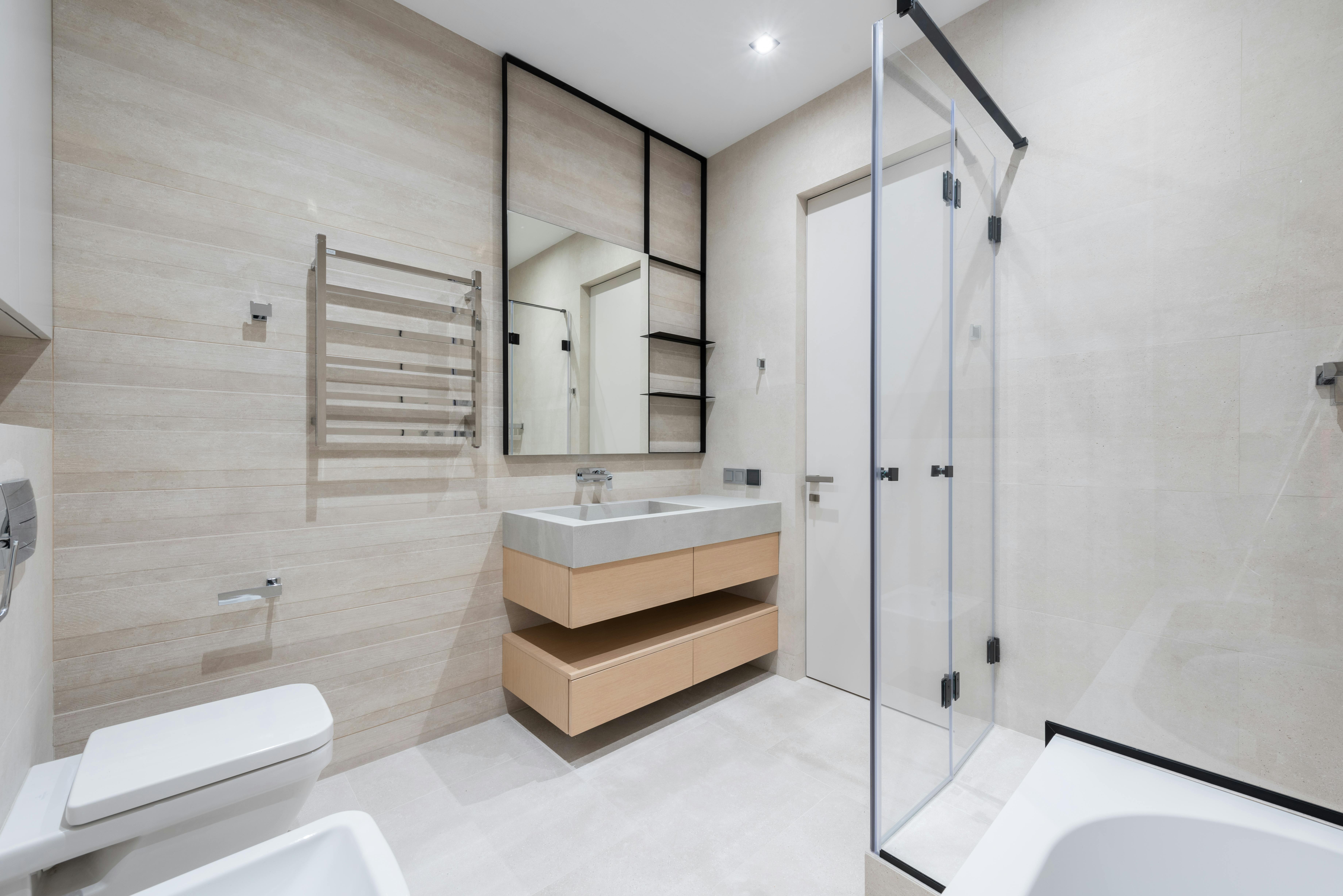 bathroom with toilet and bathtub near sink on counter