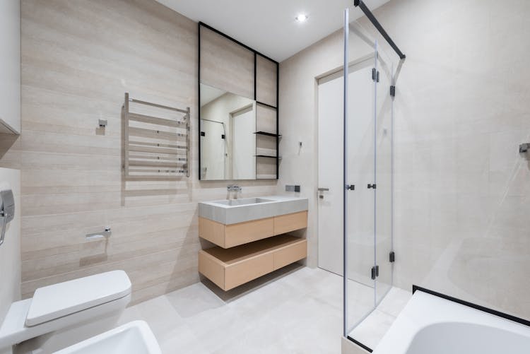 Bathroom With Toilet And Bathtub Near Sink On Counter