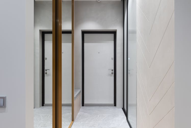 Modern Hallway With Mirror Walls And White Door