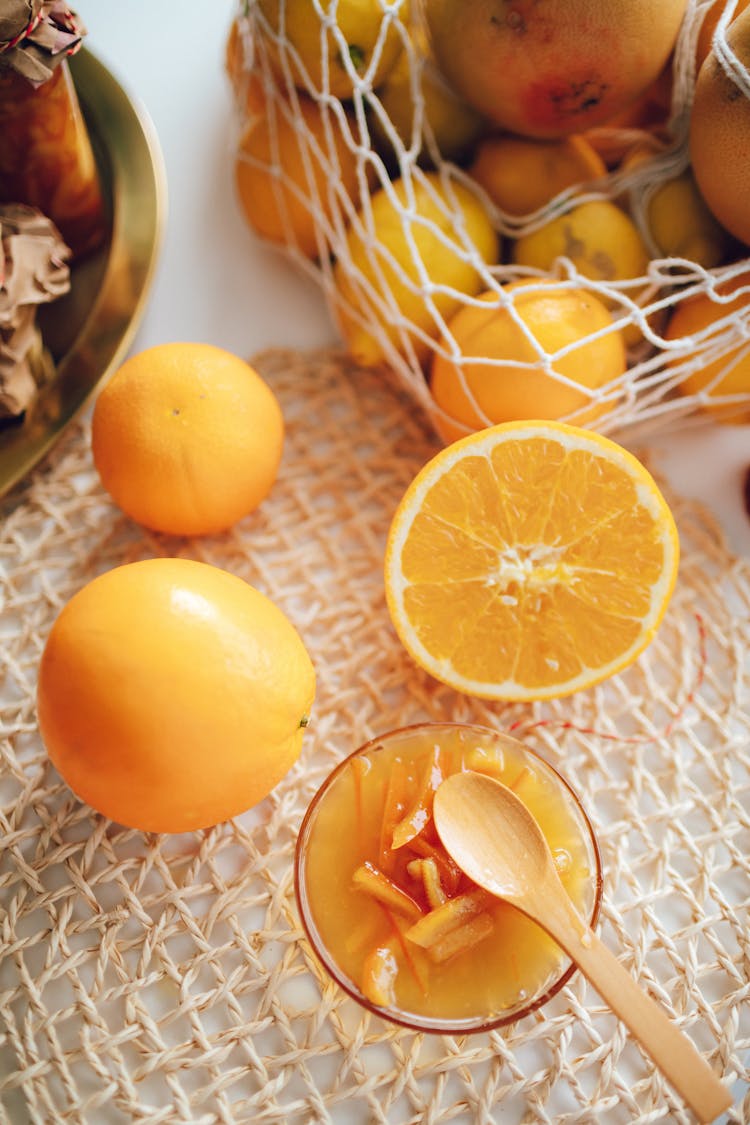 Orange Fruits And Juice With Strips Of Orange Peel