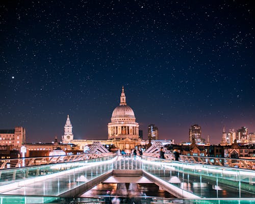 A Cathedral Near the City Buildings at Night Under the Starry Sky