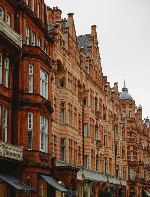 A striking view of historic Gothic-style brick buildings in London, showcasing architectural elegance.