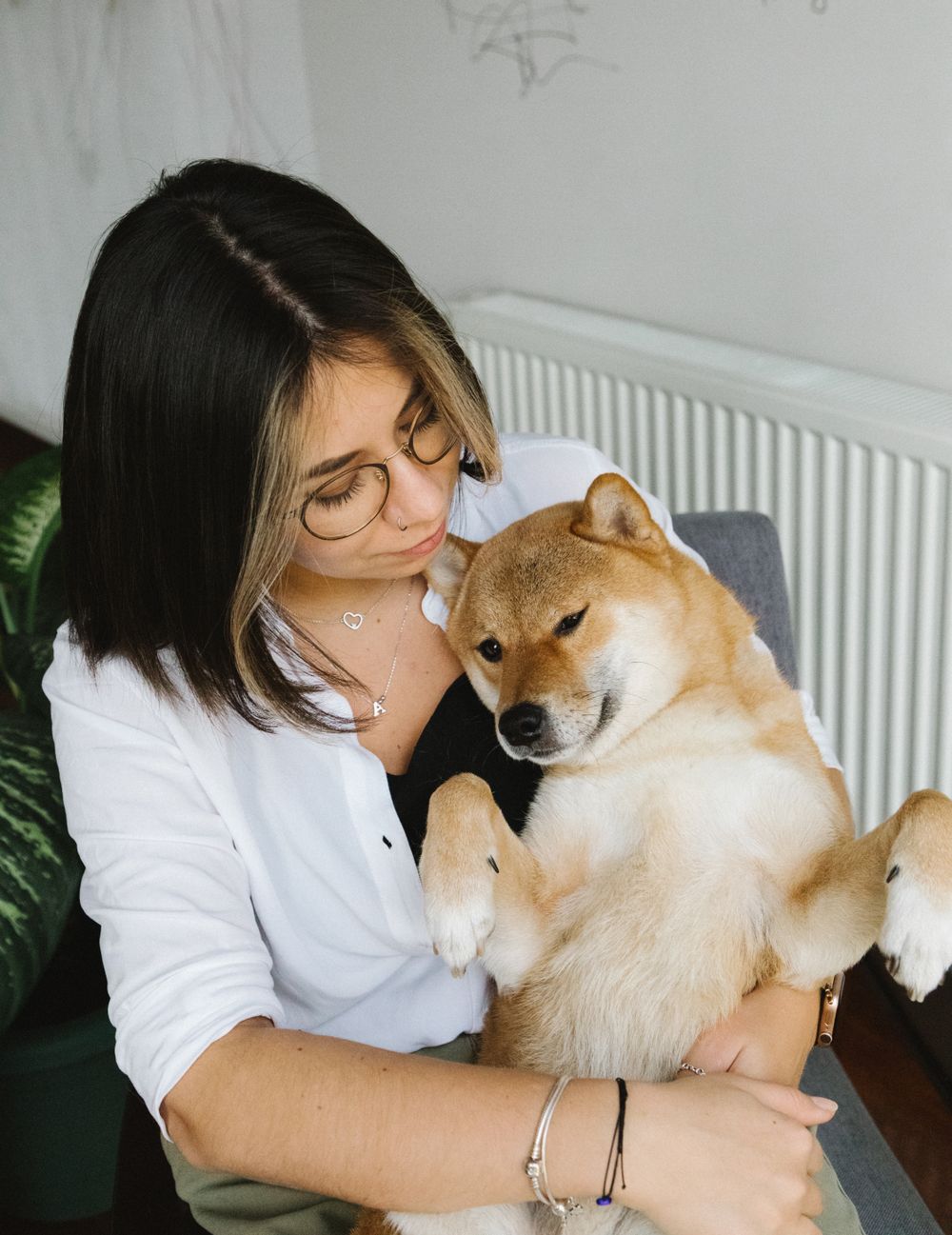 June holding a shiba inu on a comfortable armchair