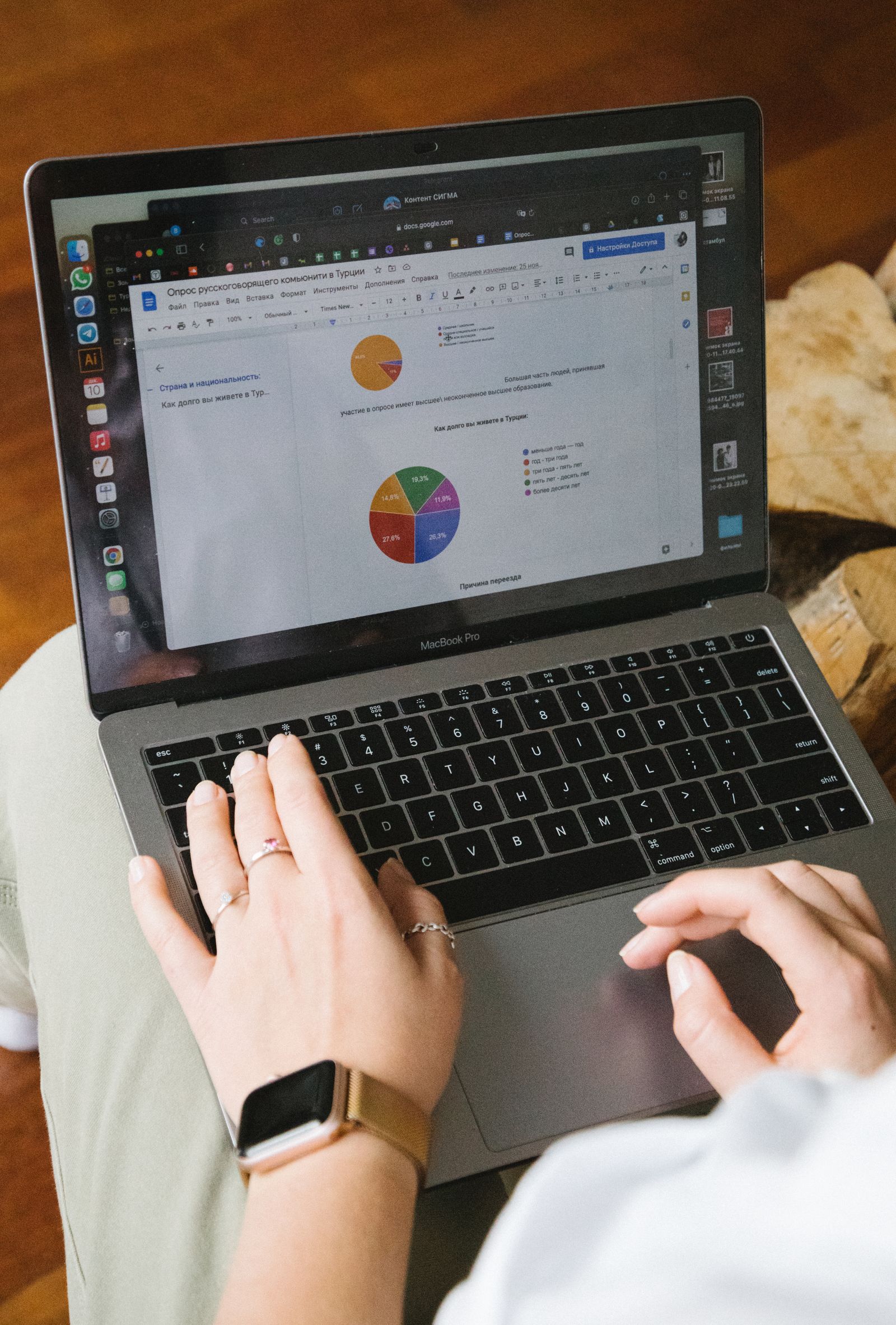 Laptop and paperwork used to review lead magnet download results and improve an opt-in page