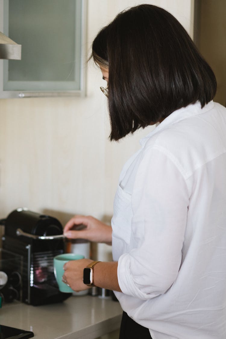 Unrecognizable Woman Preparing Coffee In Pod Coffee Machine