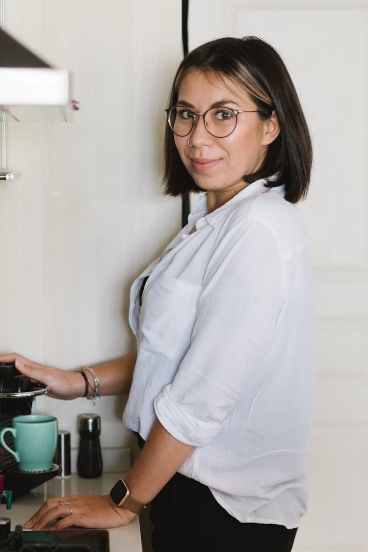Content Woman Brewing Coffee Using Pod Machine