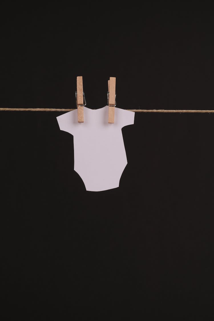 Paper Shape Of Baby Uniform Attached To String