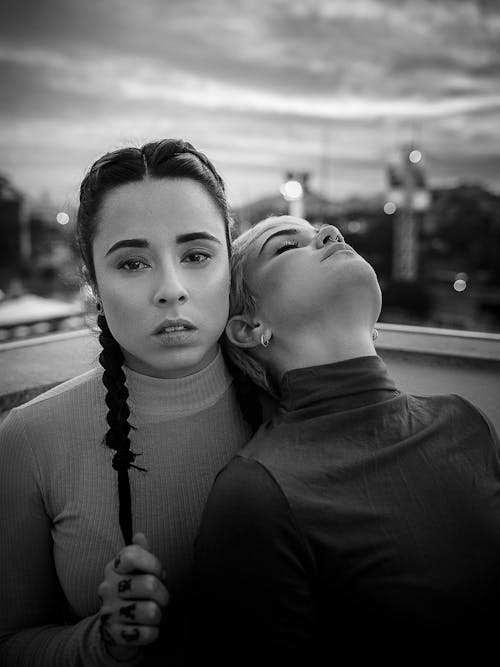 Young woman with braids and relaxed friend in city