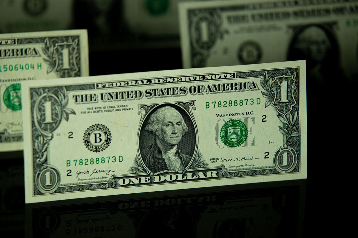 US one dollar banknotes on a dark background
