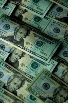 Close-up of multiple US twenty dollar bills arranged in a pattern, showcasing financial abundance.