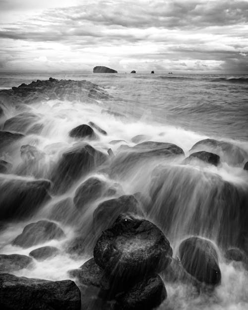 Grayscale Photo of a Rocky Seashore