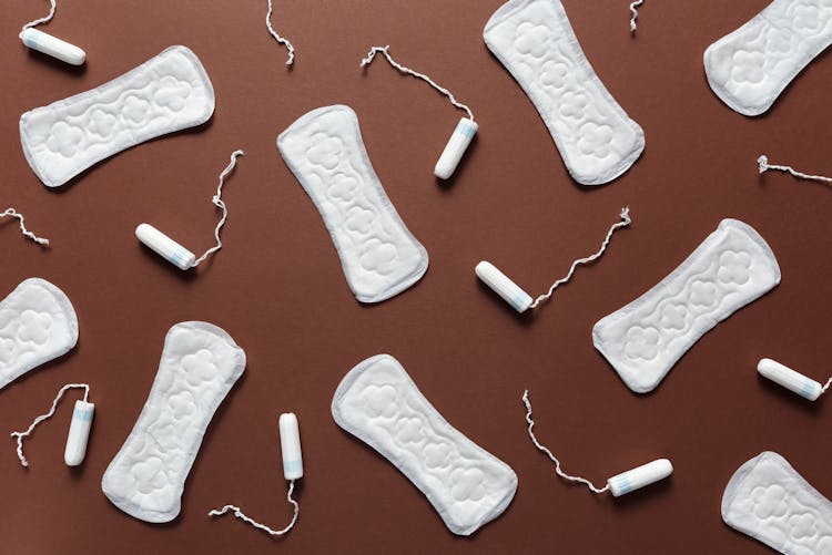 Sanitary Napkins And Tampons On The Brown Background