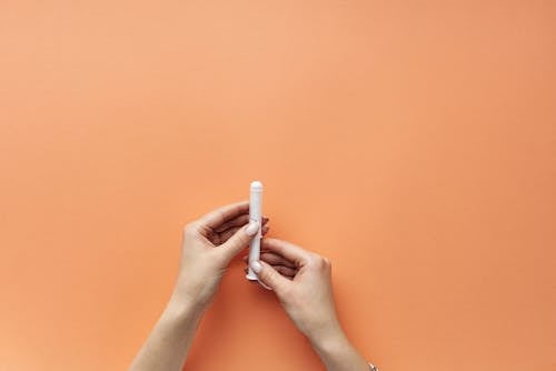 Free A Person Holding a Tampon Stock Photo