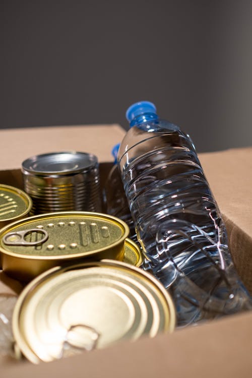 Free Canned Goods and Bottle of Water in a Carton Box Stock Photo