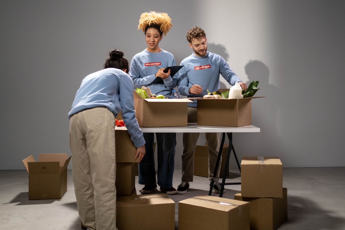 Volunteers sorting donated food into boxes
