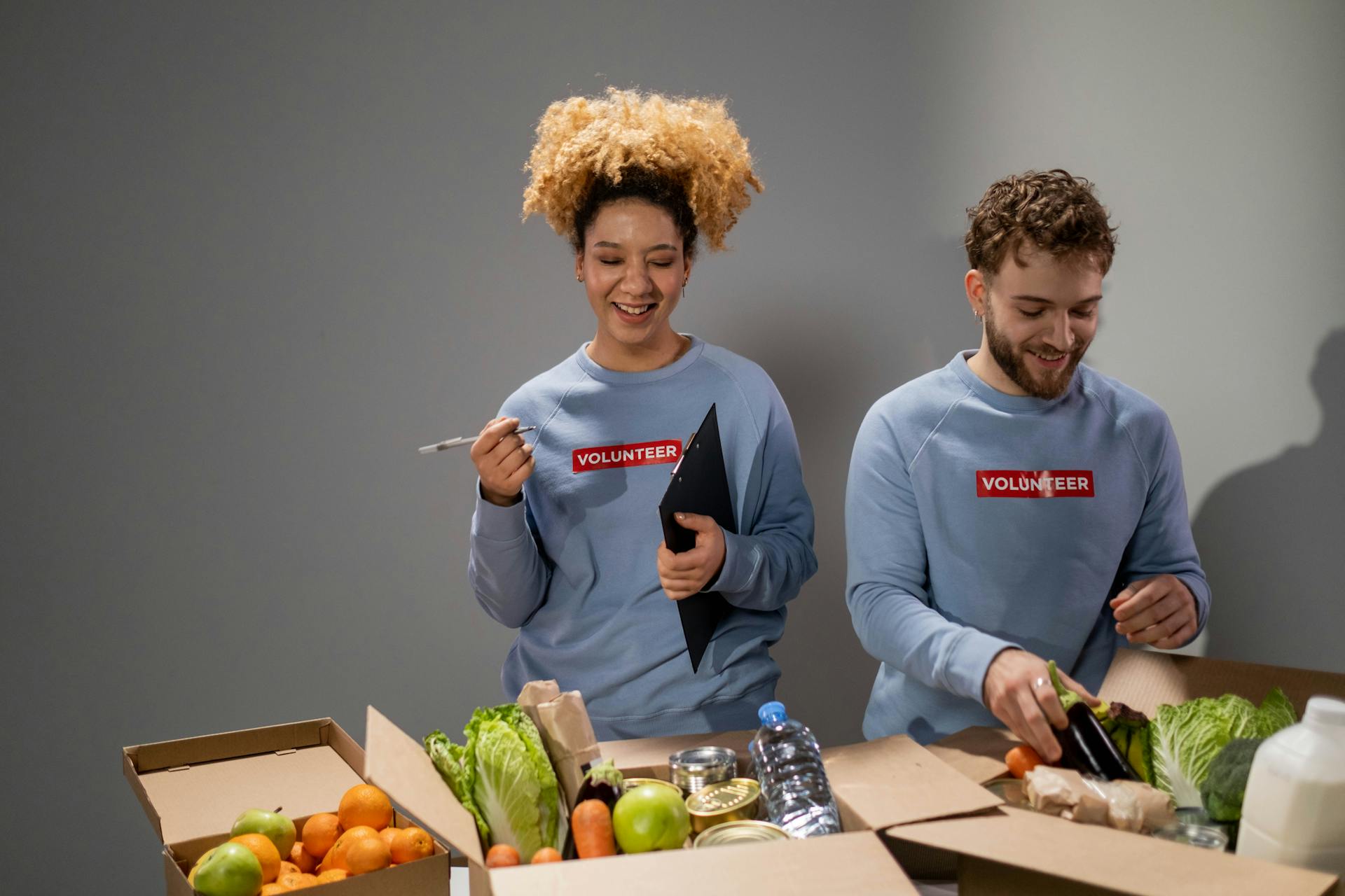 Two Volunteers Packing the Charity Goods