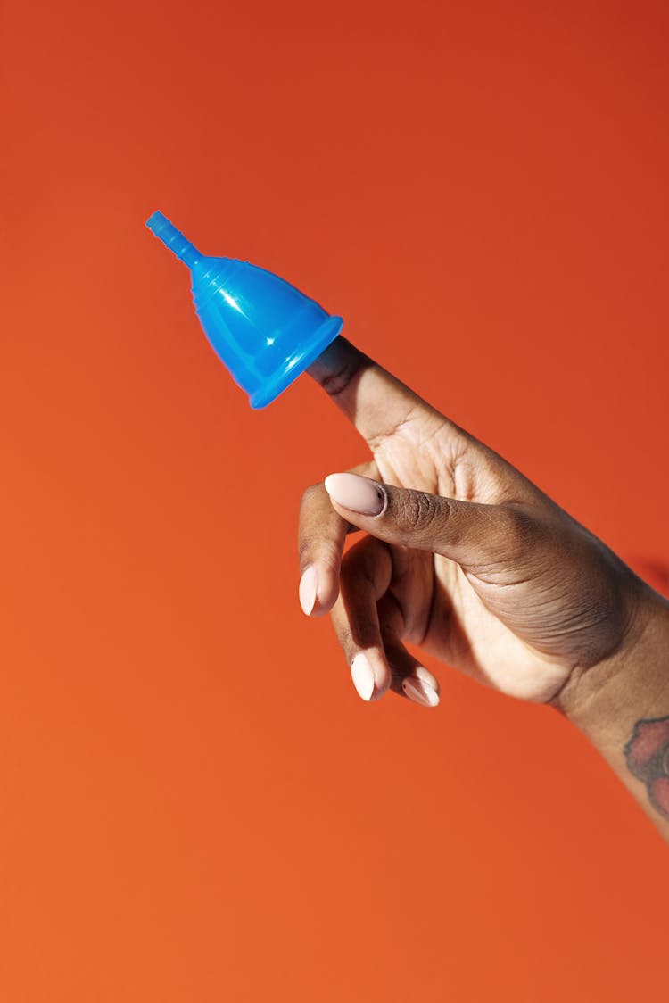 Person Holding Blue Plastic Cup