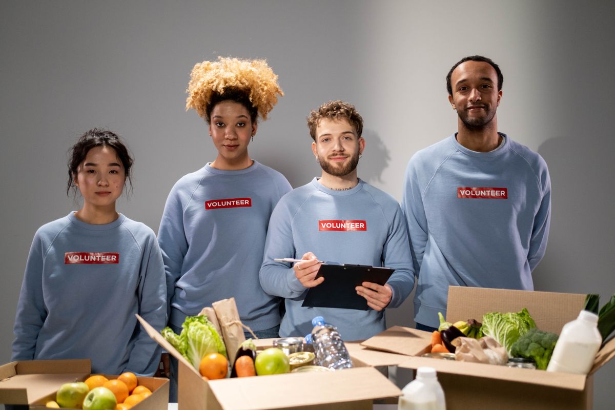 Volunteers in matching sweaters organizing food donations