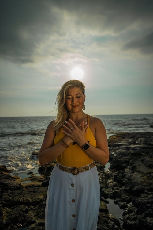 Free Calm woman meditating on beach Stock Photo