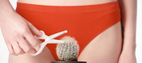 A Woman in Orange Underwear Holding a Scissor