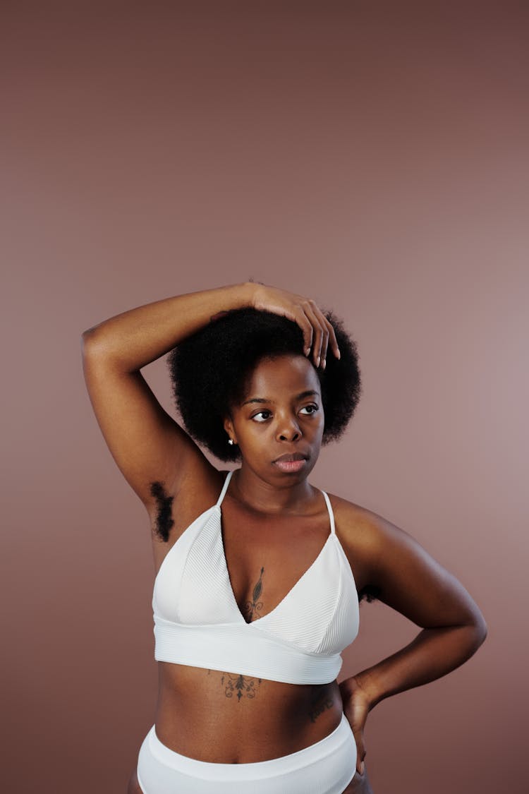 A Woman Posing In Her White Underwear