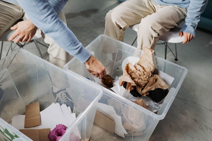 Hands sorting items for recycling