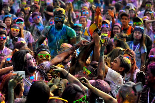 Colorful Holi festival with people covered in vibrant powders, enjoying the celebration.