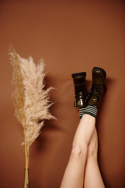 A Woman Feet Wearing a Green Boots