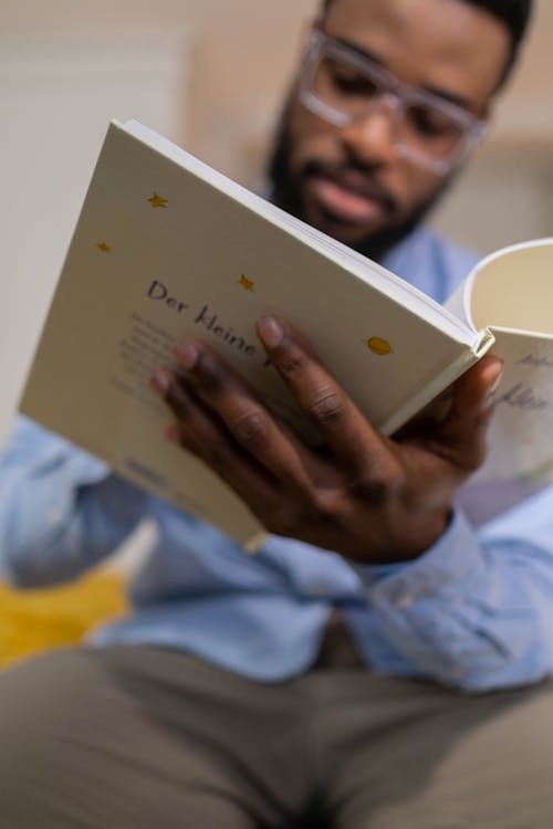Free Man with Eyeglasses Reading a Book Stock Photo