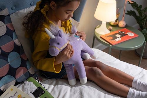 Free A Girl Holding a Stuffed Toy Stock Photo