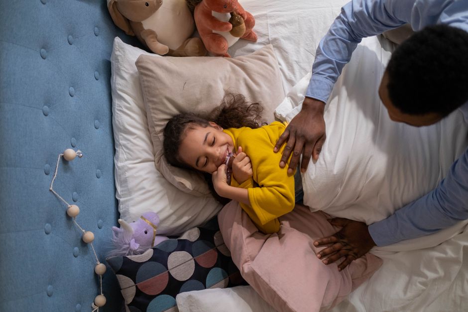 Photo by cottonbro studio on Pexels A loving father enjoys playful moments with his daughter tucked in bed with plush toys. - Photo by cottonbro studio on Pexels