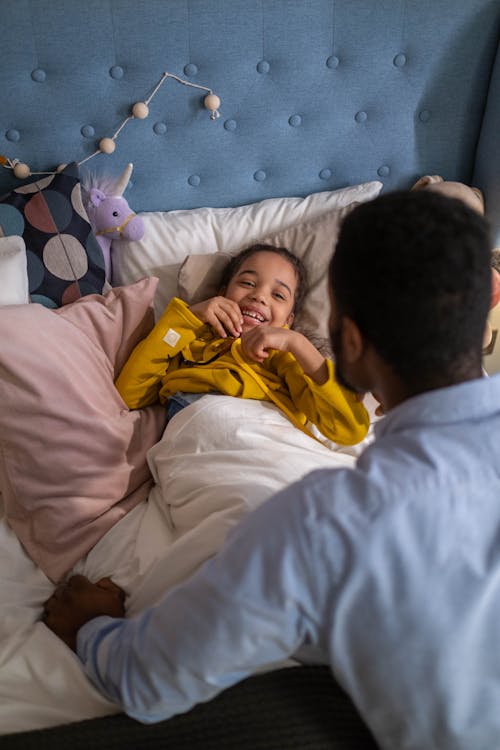 Free Girl Lying Down on the Bed Smiling Stock Photo