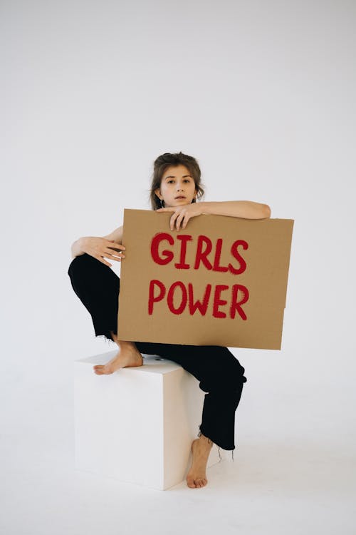 Brunette Holding Placard with Girls Power Slogan