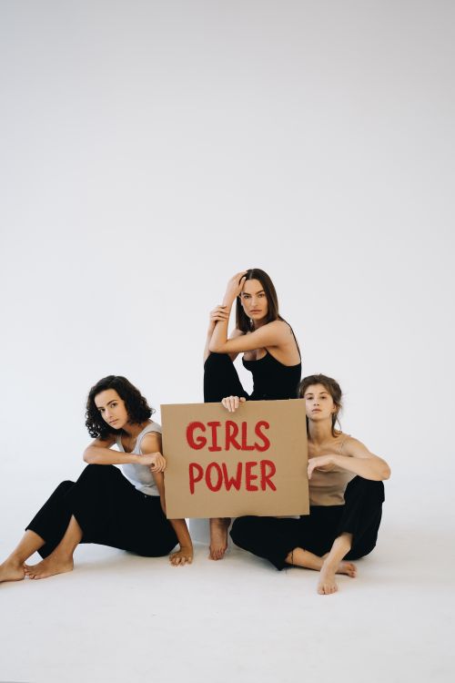 Free Three women advocating for gender equality with a Girls Power sign. Stock Photo