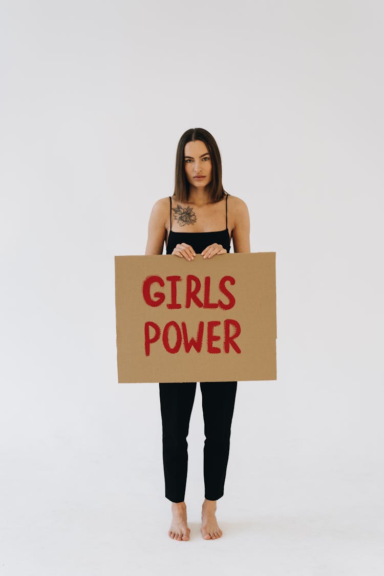 A Woman Holding A Placard About Girls Power