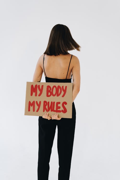 Free Back View of a Woman Holding a Placard About My Body My Rules Stock Photo