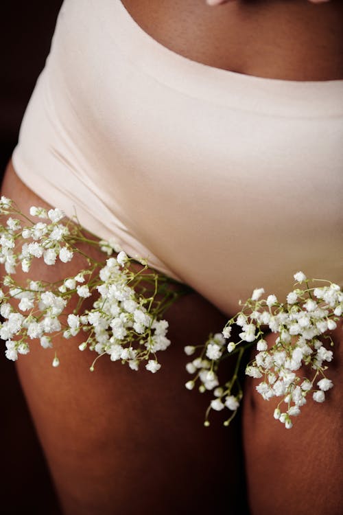 White Flowers on a Person Wearing White Underwear