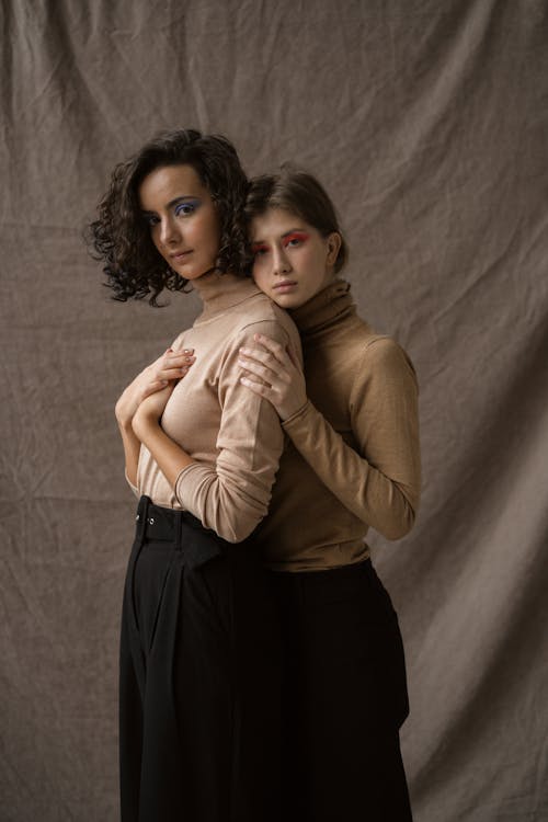 Women Standing Close Next to Each Other while Projecting on the Camera