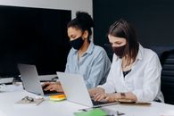 Woman in White Dress Shirt Using Macbook