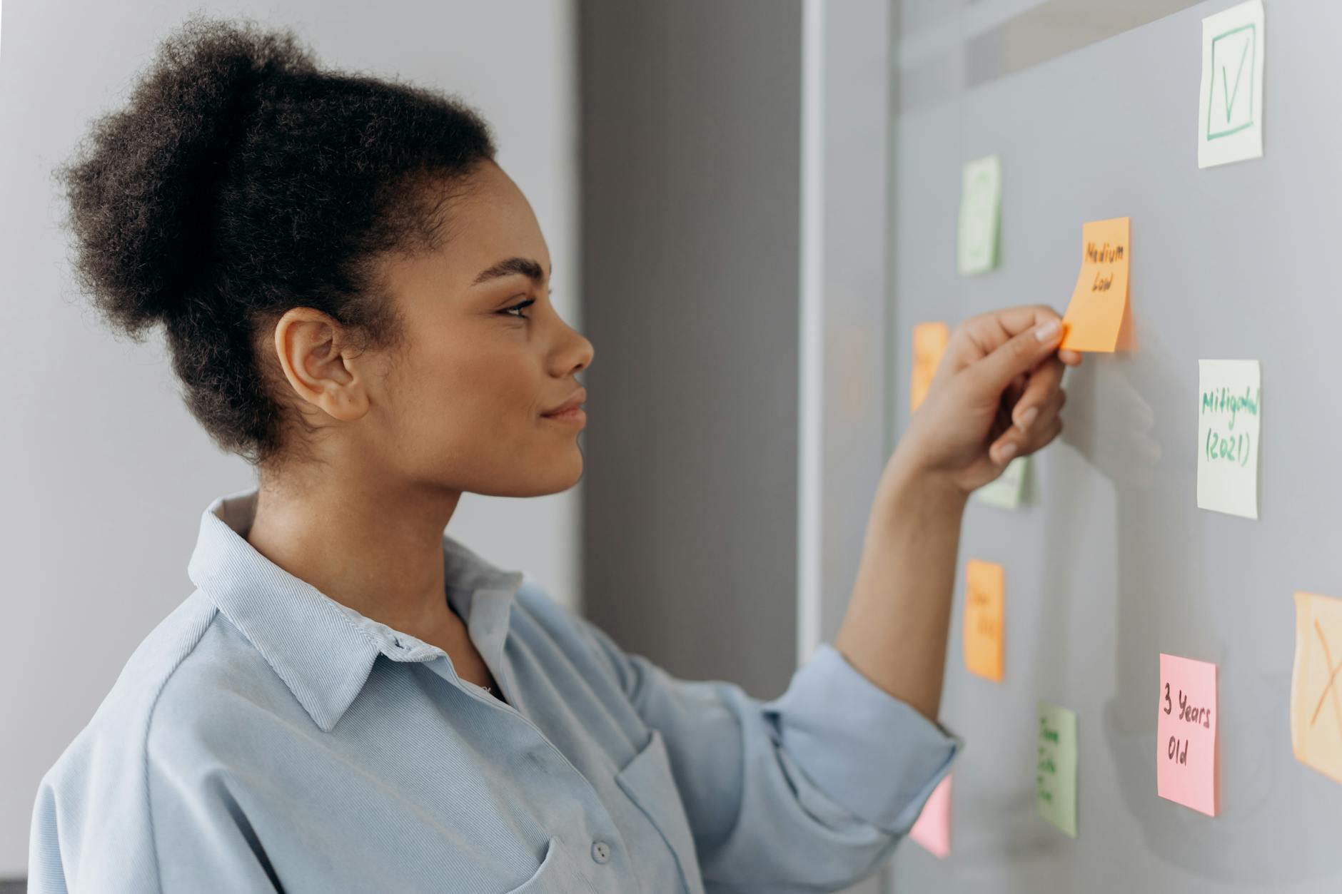 A Woman Sticking a Stick Note