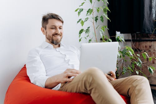 Free A Happy Man Using His Laptop Stock Photo