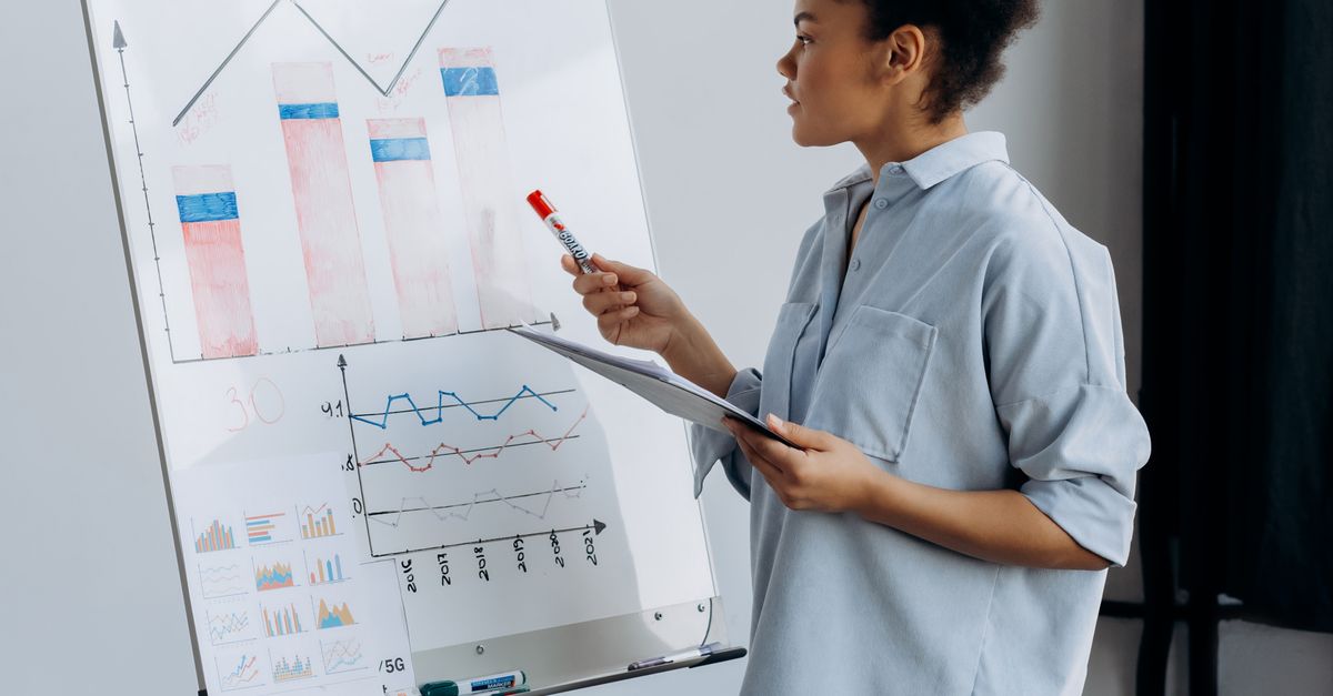 Graph Explaining Something A Woman Explaining the Graph on the Board · Free Stock Photo