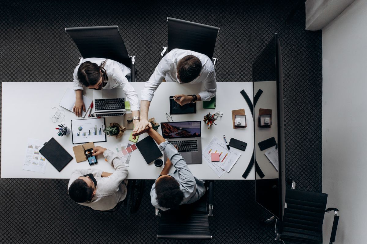 supply chain management team reviewing global sourcing strategy at conference table