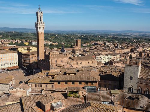Free A panoramic aerial view of Siena's historic Torre del Mangia and surrounding cityscape in Tuscany, Italy. Stock Photo