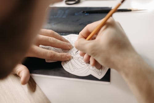 An Artist Drawing on Paper