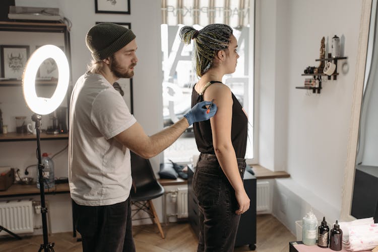 Man Drawing On Woman's Arm