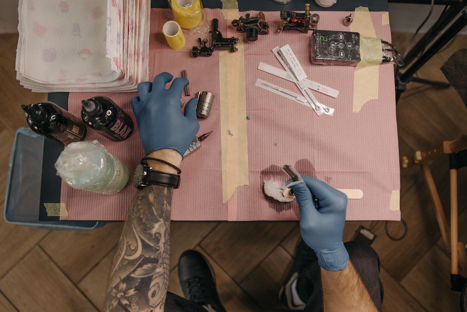 A clean tattoo studio station being sanitized between clients with barrier film and disinfectant A clean tattoo studio station being sanitized between clients with barrier film and disinfectant