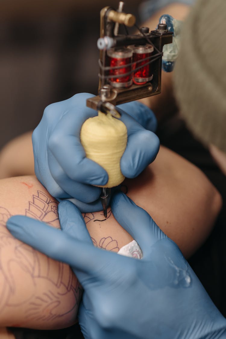 Tattoo Artist Drawing A Tattoo