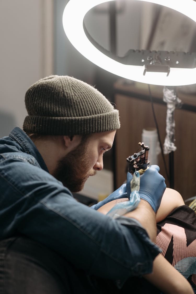 Man Tattooing A Client