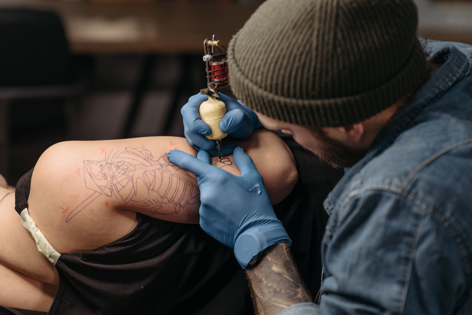 tattoo artist and client discussing placement and design direction